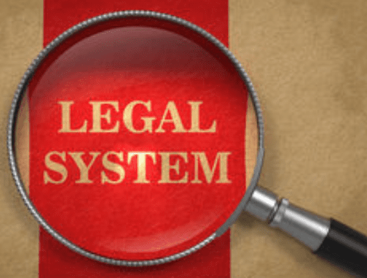 A magnifying glass on the word legal system.