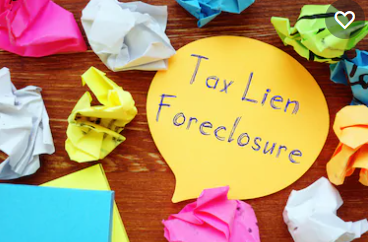 A yellow sign that says tax lien foreclosure.