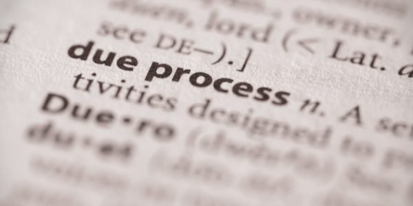 A close up of the word process in a dictionary