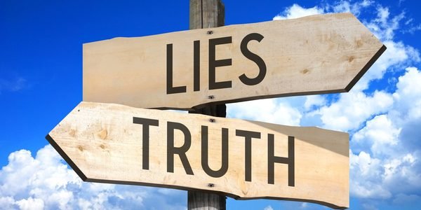 A wooden sign that says lies and truth