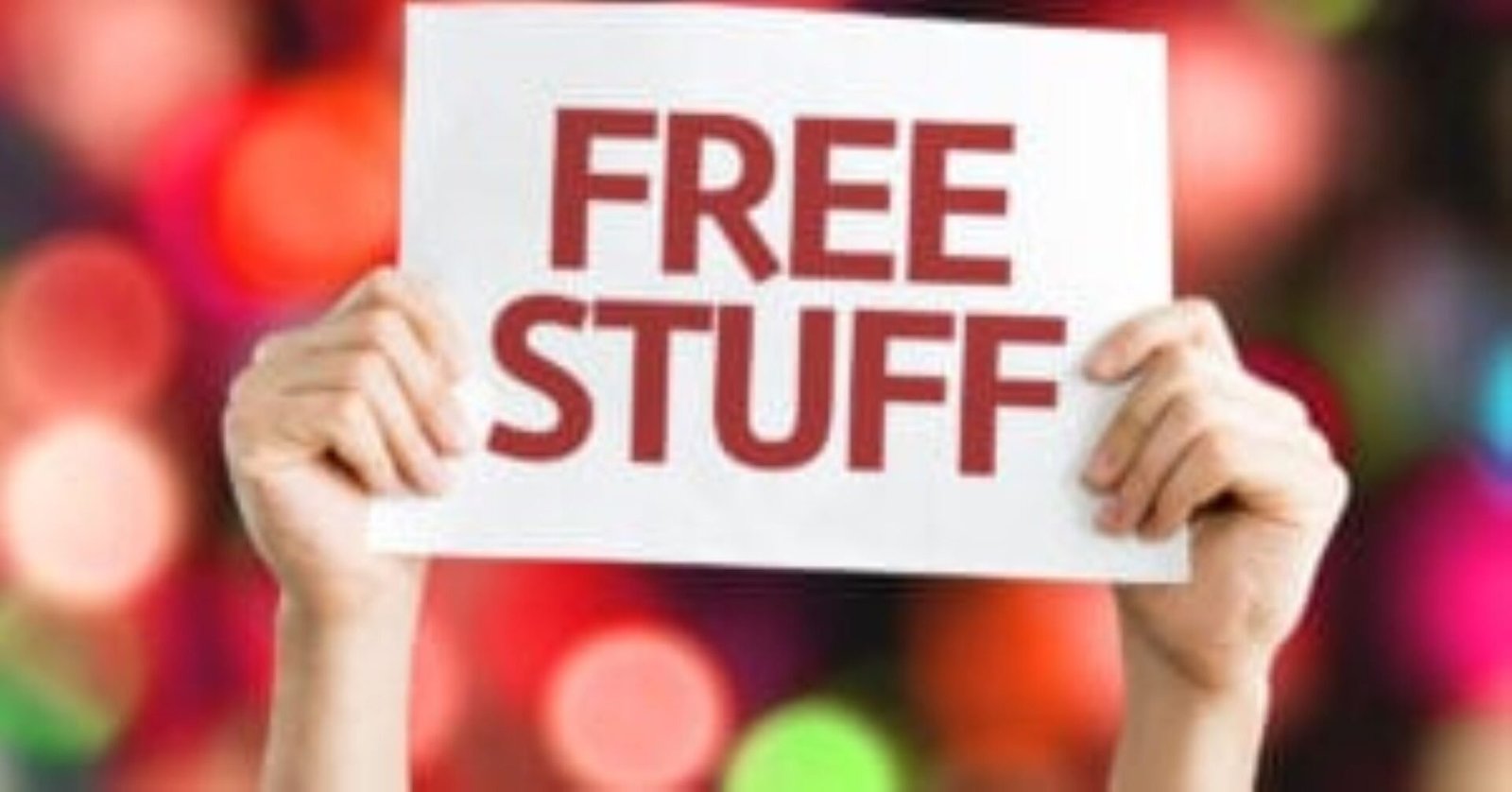 A person holding up a sign that says free stuff.