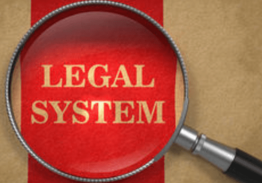 A magnifying glass over a legal system word